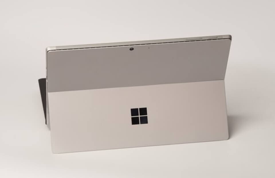 tech-news-post-featured-img-02 A Microsoft Surface tablet is shown from the back, displaying its built-in kickstand and the Microsoft logo, making it a versatile choice for families of teens looking for both productivity and entertainment.