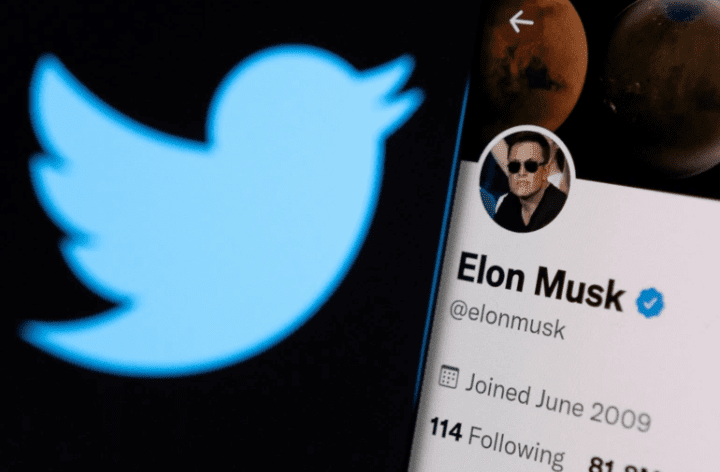 Screenshot_20221026-123647-1.png Close-up of the Twitter logo next to a smartphone screen displaying a verified profile for Elon Musk, showcasing his join date as June 2009 and various follower stats, capturing the energetic buzz among Twitter users.