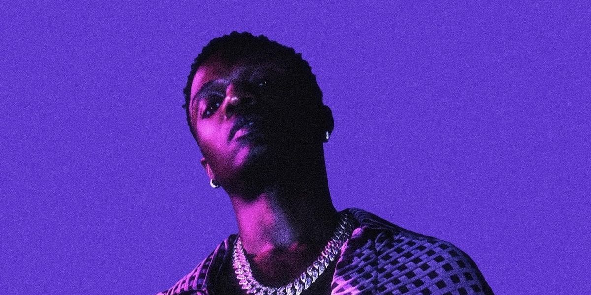 1668210461_wizkid.jpg This week, a person wearing a patterned shirt and a chain necklace stands against a purple background, creating an aesthetic that feels as compelling as must-hear songs.