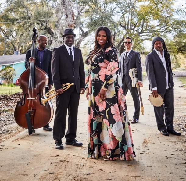 unnamed45_20.jpg Five musicians pose outdoors; a woman in a floral dress stands at the center, surrounded by four men in suits holding their respective instruments: double bass, trumpet, guitar, and tambourine. This acclaimed group celebrates Gullah music and proudly won the BEST REGIONAL ROOTS ALBUM with their band Ranky Tanky.