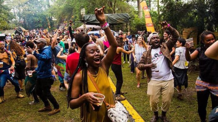 Nyege Nyege Festival 2023: Dancing group at music festival. Nyege Nyege Festival 2023: Dancing group at music festival.
