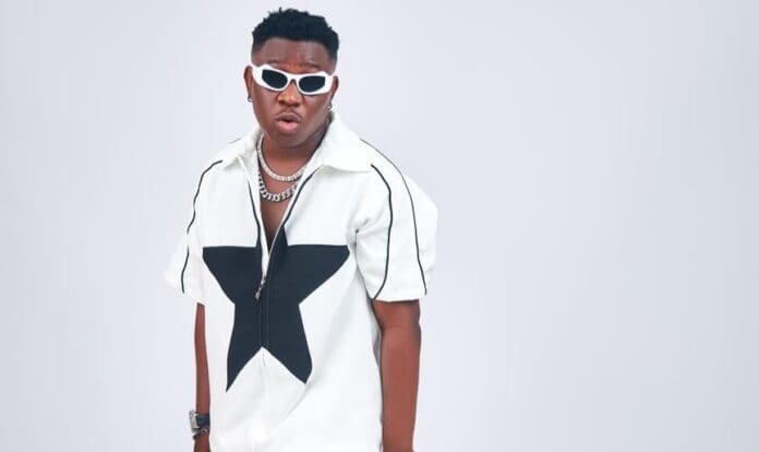 Emerging music sensation sporting sunglasses and a white shirt, Dami TNT, poised to make waves in the music industry. Emerging music sensation sporting sunglasses and a white shirt, Dami TNT, poised to make waves in the music industry.