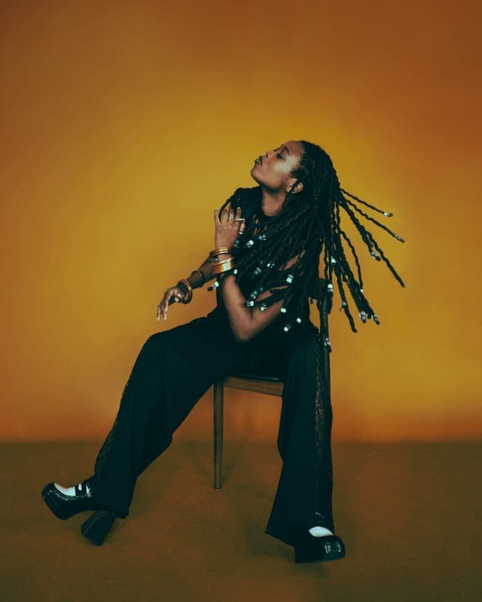 Lady Donli, a woman with dreadlocks, sitting on a chair during an interview for her latest album. Lady Donli, a woman with dreadlocks, sitting on a chair during an interview for her latest album.