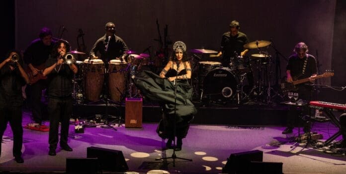 A group of people on stage with top Brazilian musical instruments performing at UC Theatre. A group of people on stage with top Brazilian musical instruments performing at UC Theatre.