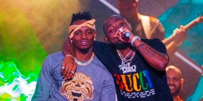 Two men standing next to each other at a concert with Diamond Platnumz and Zuchu. Two men standing next to each other at a concert with Diamond Platnumz and Zuchu.