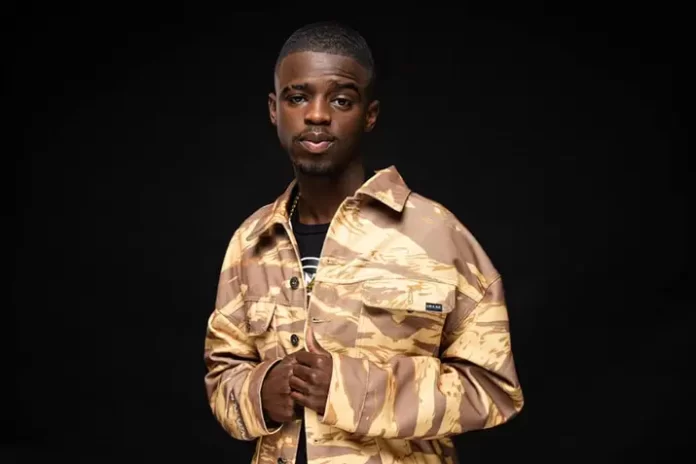 A man in a camouflage jacket posing for a photo during the Main Mix event. A man in a camouflage jacket posing for a photo during the Main Mix event.