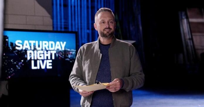 Matthew Perry standing in front of a television with the words SNL. Matthew Perry standing in front of a television with the words SNL.