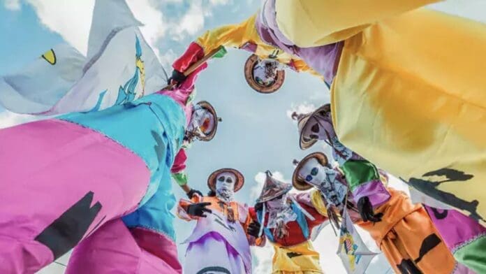 A group of people in colorful costumes celebrating at the Caribbean's Best Christmas Festival. A group of people in colorful costumes celebrating at the Caribbean's Best Christmas Festival.