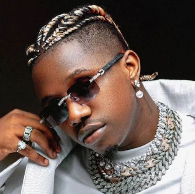 Otile Brown, a Tanzanian Bongo star, with sunglasses is posing for a photo. Otile Brown, a Tanzanian Bongo star, with sunglasses is posing for a photo.