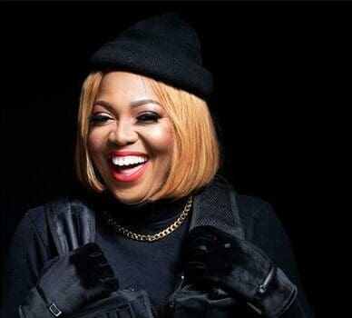 A smiling woman wearing a black jacket and hat, nominated for Sama award. A smiling woman wearing a black jacket and hat, nominated for Sama award.
