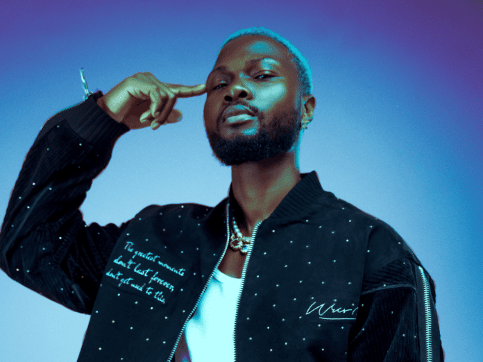 WurlD, a man in a black jacket, posing for a photo while releasing music. WurlD, a man in a black jacket, posing for a photo while releasing music.