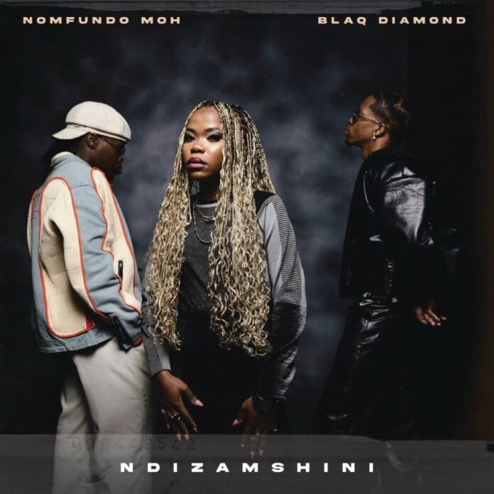 Nomfundo-Moh-–-Ndizamshini-ft.-Blaq-Diamond.jpg Against a dark backdrop, three people strike a pose; two glance away while one with braided hair faces forward. The text proudly showcases: “Nomfundo Moh, featuring Blaq Diamond and Ndizamshini.”.