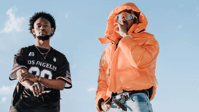 Wiziboy_20250415_092500_0000.png Two individuals pose against a clear sky, channeling their inner BGRB vibe. One sports a jersey, while the other rocks an orange puffer jacket with a face covering and sunglasses, embodying the iconic Bad Guy Rude Boy attitude.
