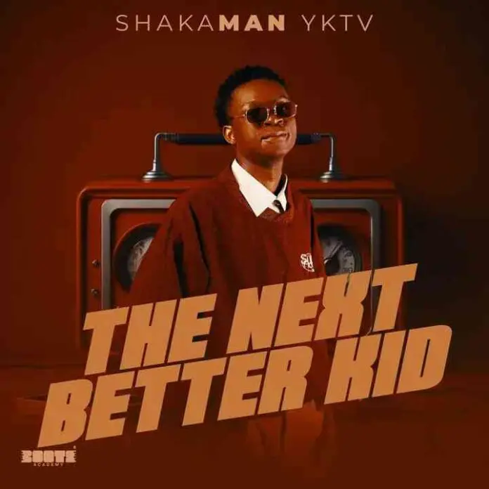 img_1_1746524405317.jpg A person in sunglasses and a brown sweater stands in front of a vintage radio, with text above reading "The Next Better Kid" and "ShakaMan YKTV," hinting at the upcoming The Next Better Kid Album tracklist.