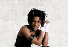 LaCabra Stakes His Claim With Debut Album “MR BULLY” Young person with braided hair and braces poses in black clothing with white hand wraps against a plain background; "LaCabra" debut album parental advisory label is visible in the bottom right corner.