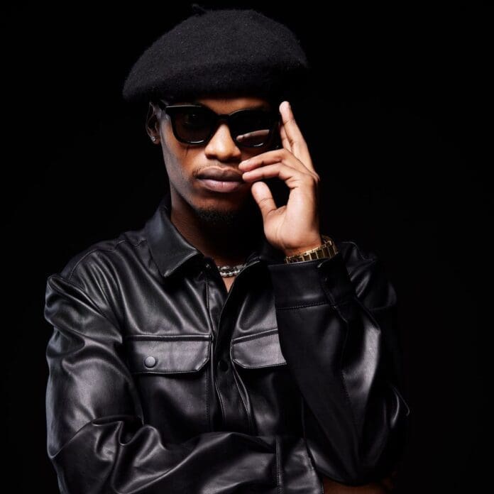 A man wearing sunglasses and a leather jacket poses confidently on a black background. A man wearing sunglasses and a leather jacket poses confidently on a black background.